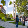 Students walking past the bell tower on campus.